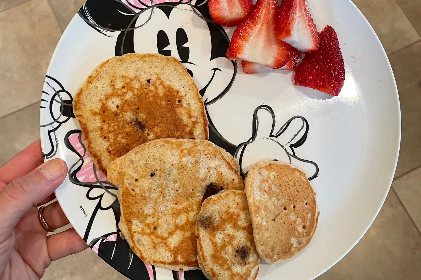Pancakes and strawberries on Mickey plate.