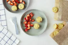 Mini muffins on plate with strawberries.