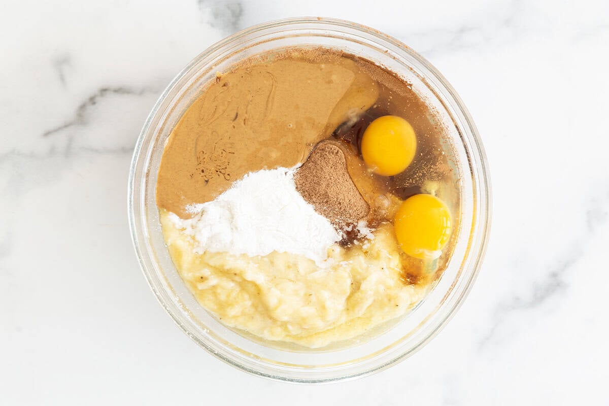 Ingredients for chocolate peanut butter muffins in glass bowl before mixing. 