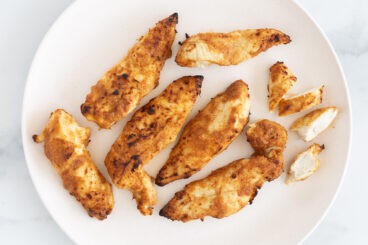 marinated chicken tenders on plate.