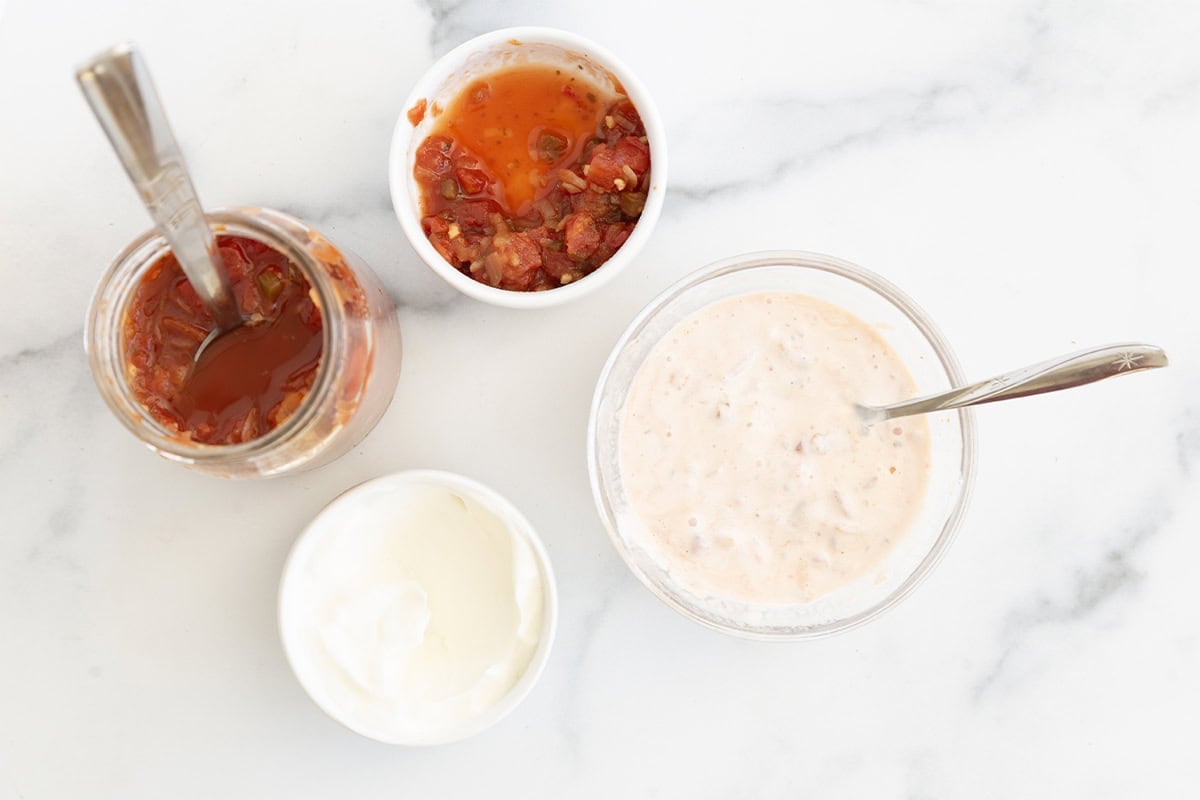 Making the sauce for burrito bowls in four bowls.