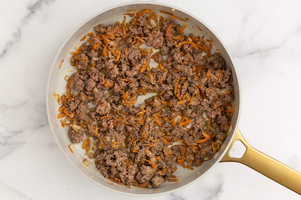 cooking ground beef for cheeseburger pasta in pan.