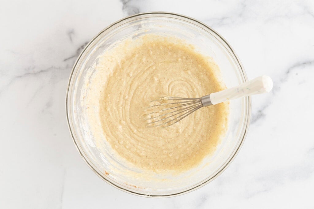 batter for donut muffins in glass bowl.