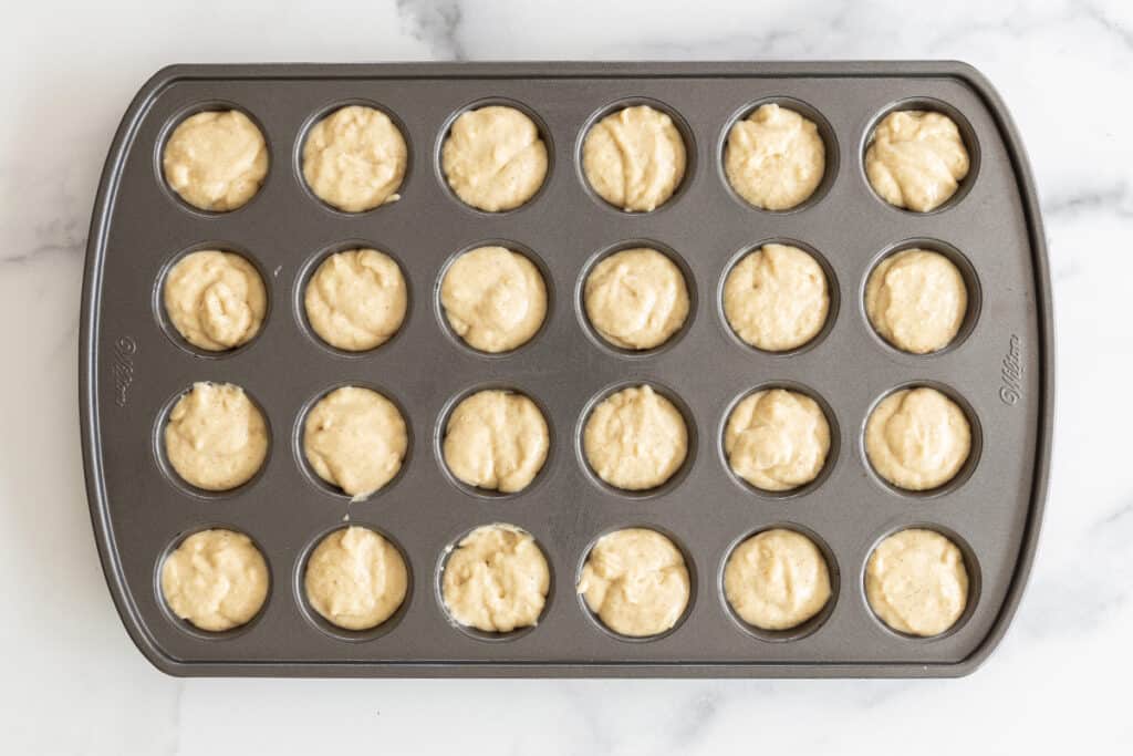 batter for donut muffins in greased mini muffin tin.