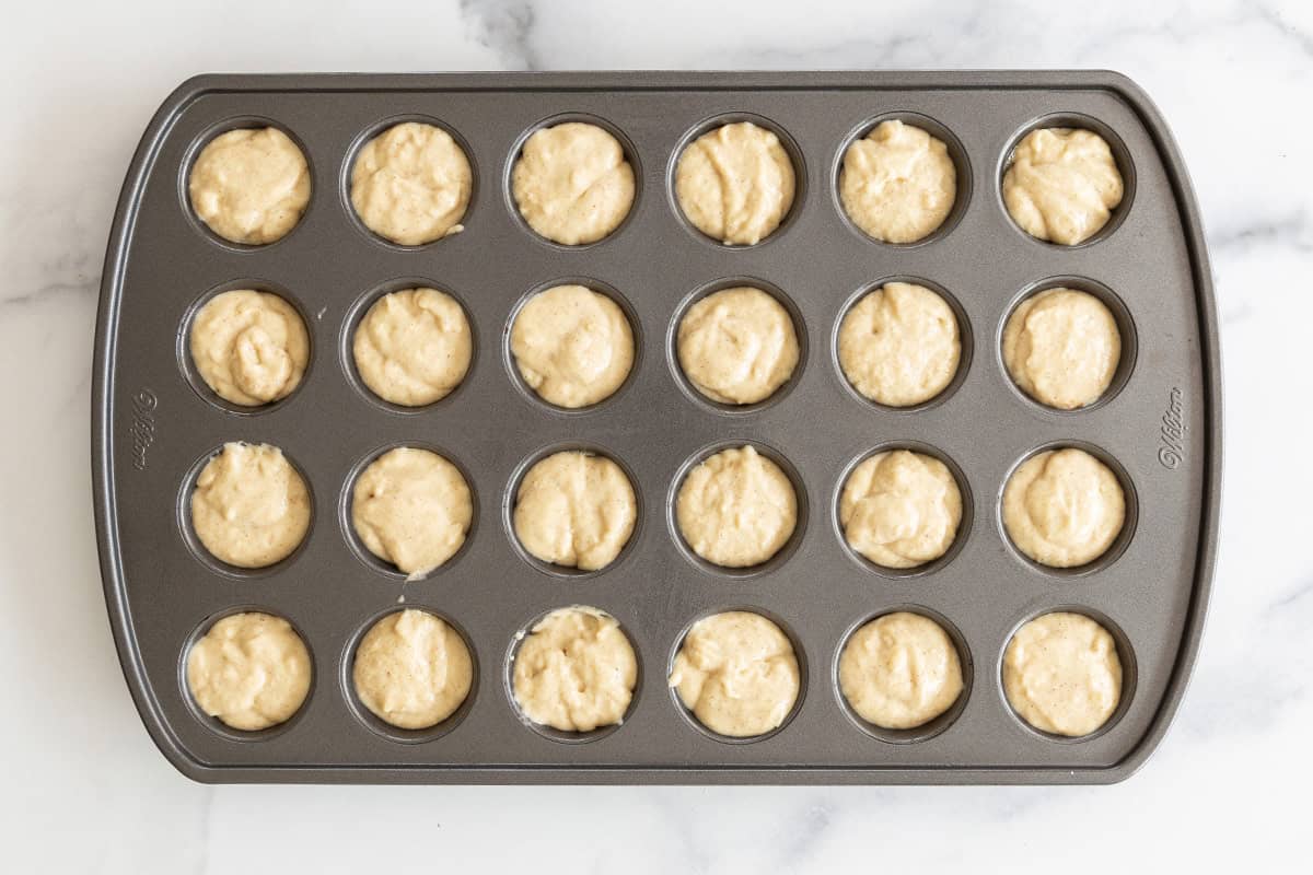 batter for donut muffins in greased mini muffin tin.