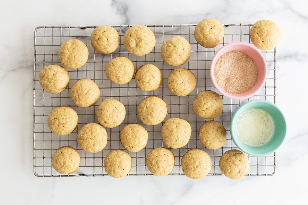 baked donut muffins with cinnamon sugar topping in bowls.