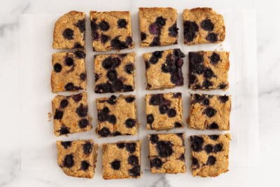 oatmeal bars with blueberries on parchment paper.
