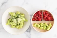 Pasta with pea sauce on two plates with sides.