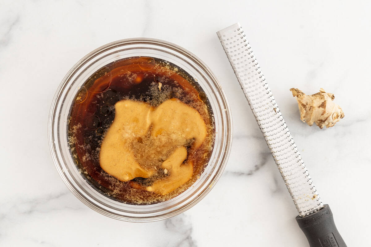 Ingredients for peanut sauce in glass bowl before mixing. 