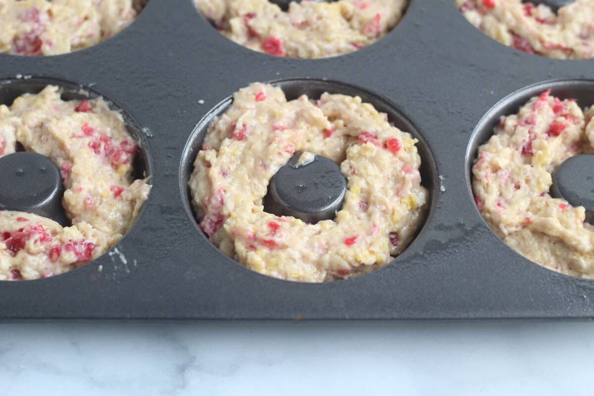 Raspberry donuts in donut pan.