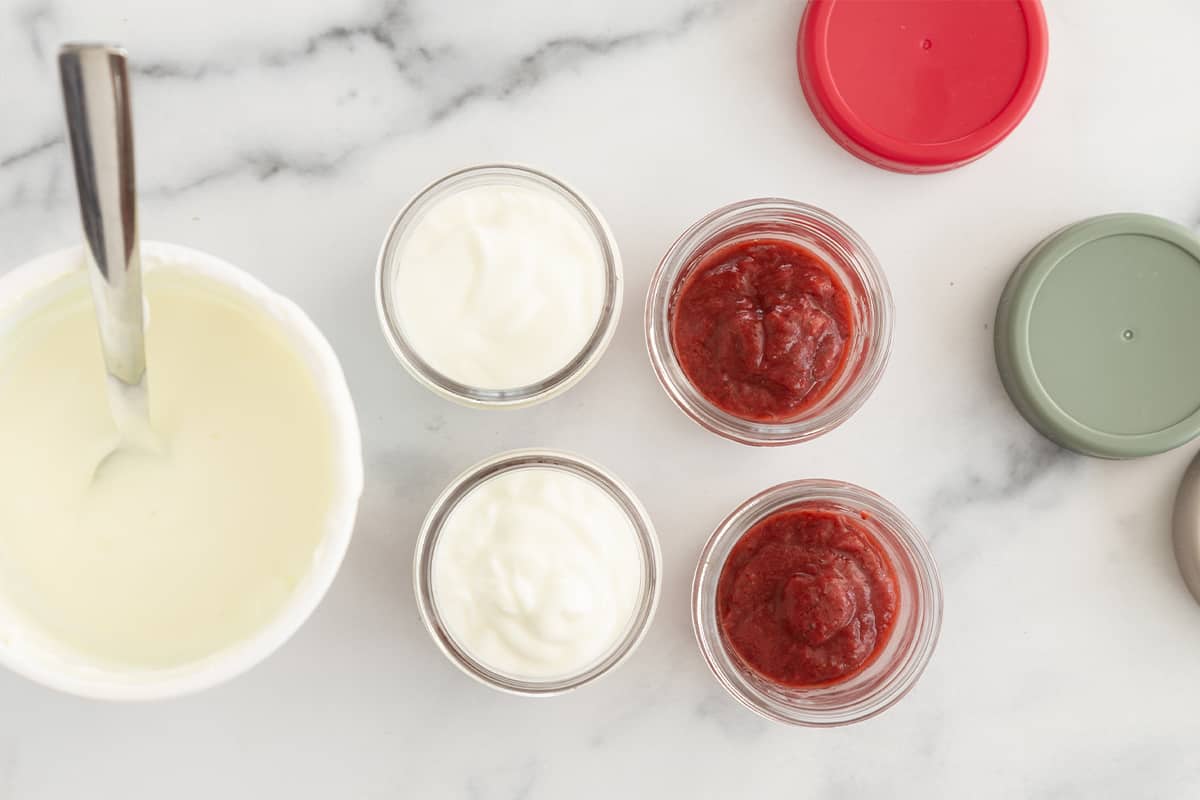 Strawberry yogurt in glass containers without lids.