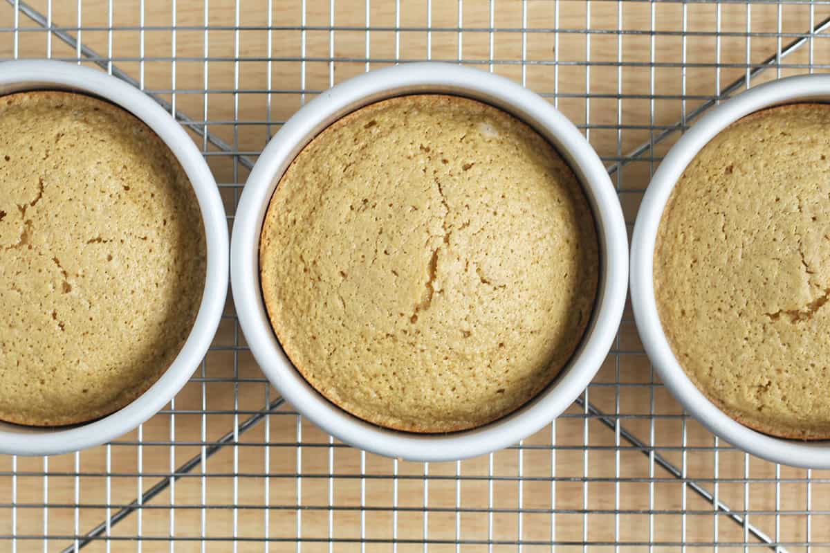 three baked layers for smash cake in pans.