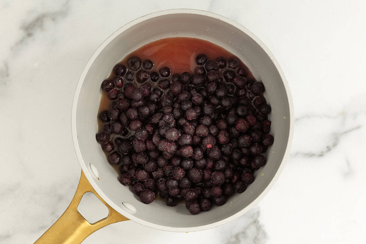 blueberries and juice in white pan on counter.