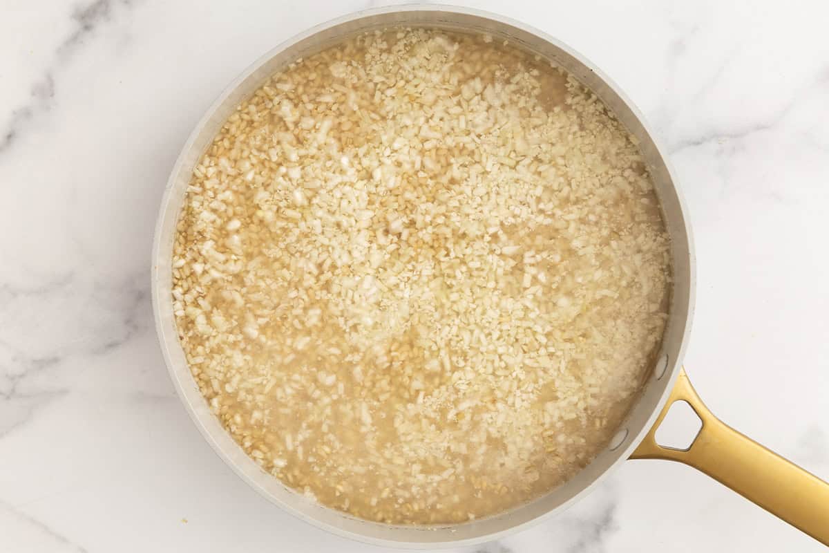 rice and water in pan on counter.