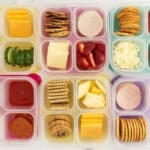 Six containers with homemade lunchables in them.