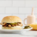 Instant pot bbq chicken sandwich on plate with sides.