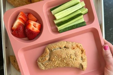 pizza pockets on pink plate.