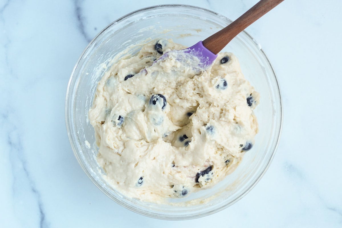 batter for mini blueberry muffins in glass bowl.