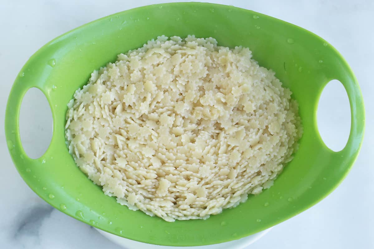 star pasta in green colander.