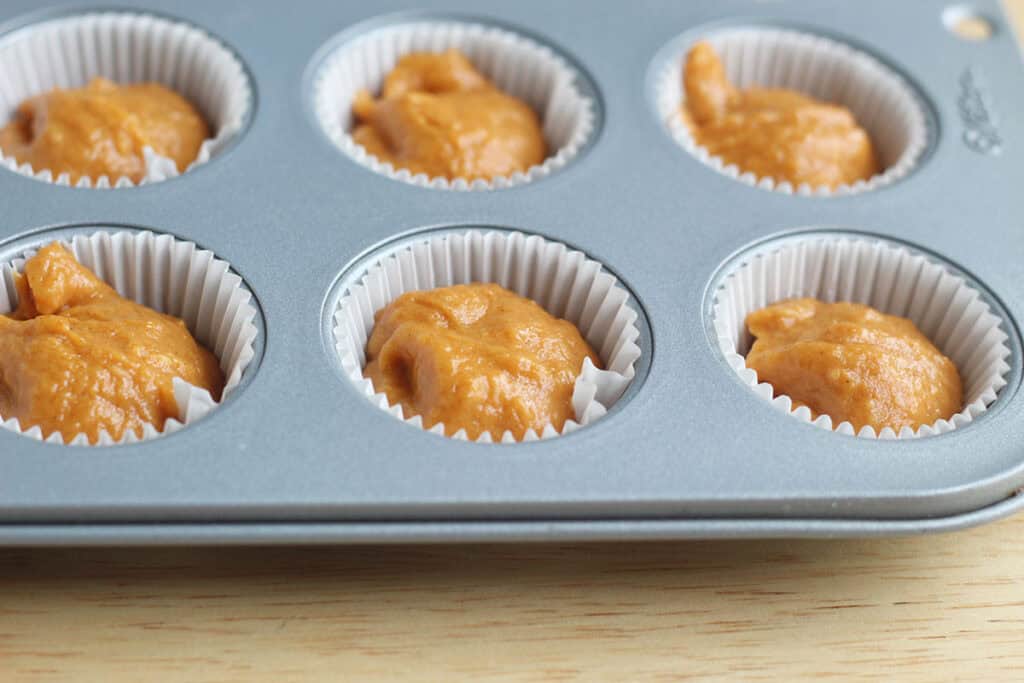 pumpkin cupcake batter in baking pan.