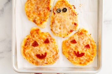 halloween pizza on baking sheet.