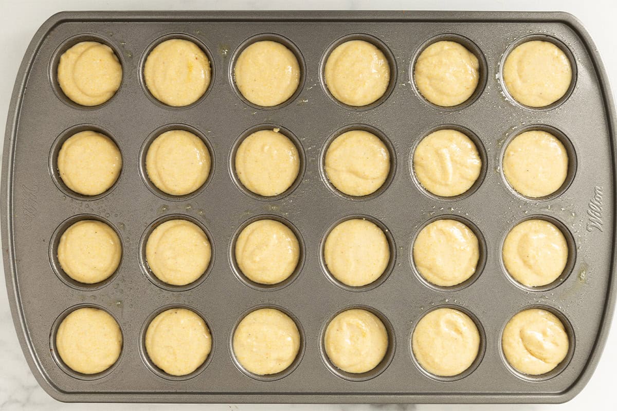 Cornbread muffins in mini muffin pan before baking.