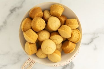 Cornbread muffins in white bowl.