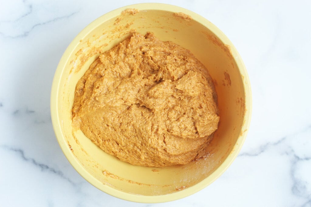batter for healthy pumpkin bread mixed in yellow bowl.