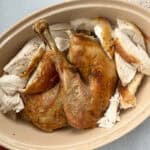 roasted spatchcock turkey in serving dish.