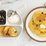 Cornmeal pancakes on two plates.