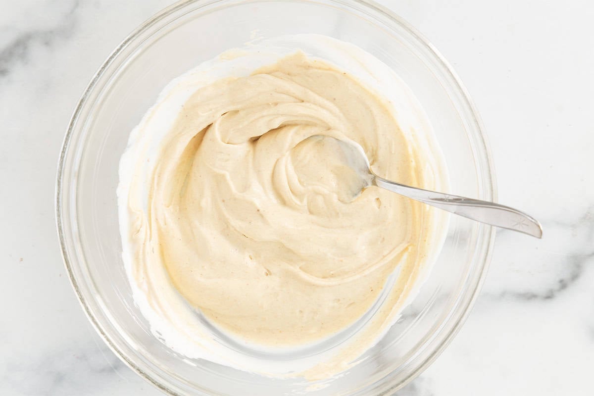 Peanut butter yogurt in glass bowl.