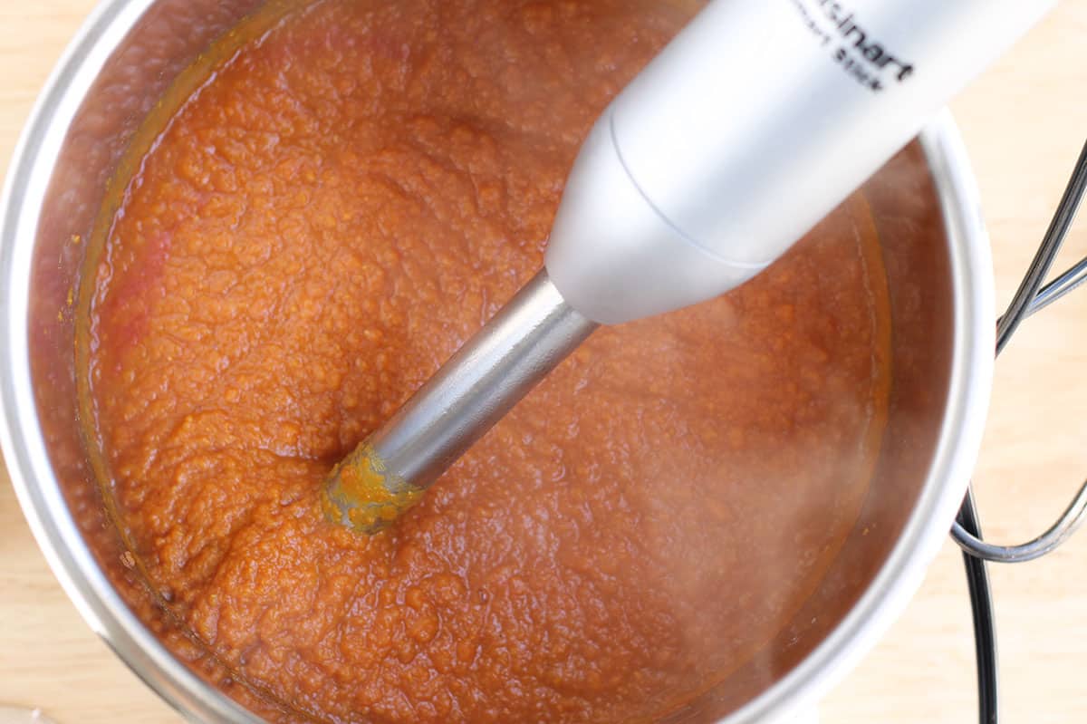 pureeing chana masala sauce with immersion blender.