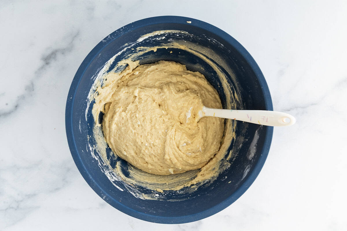 Batter for cottage cheese muffins in blue bowl.