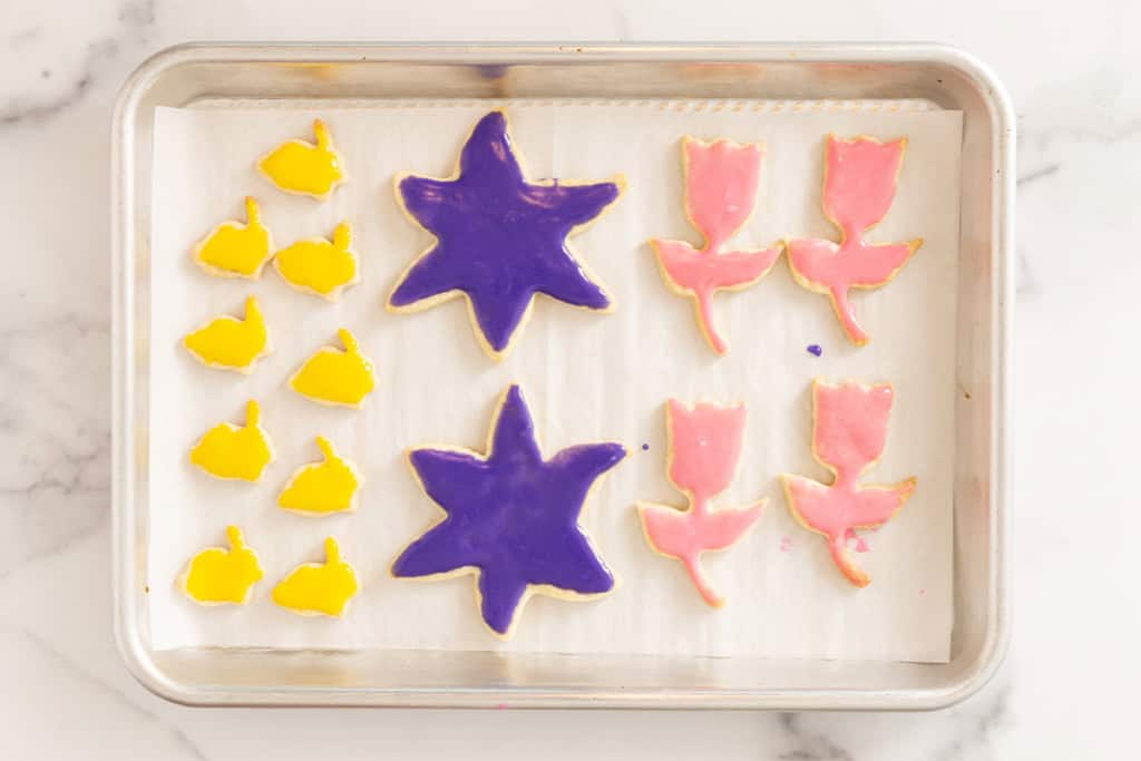 Frosted easter cookies on cookie sheet.