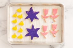 Frosted easter cookies on cookie sheet.