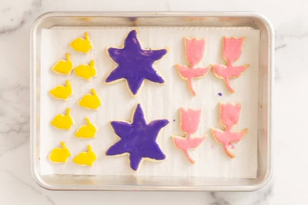 Frosted easter cookies on cookie sheet.