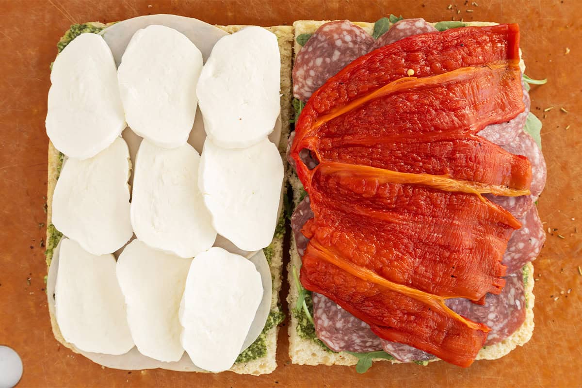 assembled focaccia sandwich on cutting board.