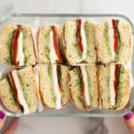 focaccia sandwich halves in glass container.