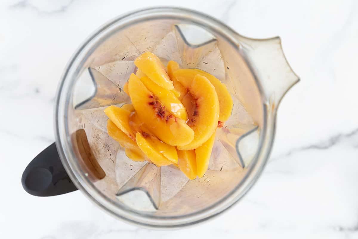 Peaches in blender for fruit popsicles. 