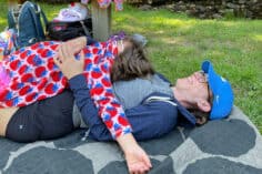 amy on blanket with child on top.