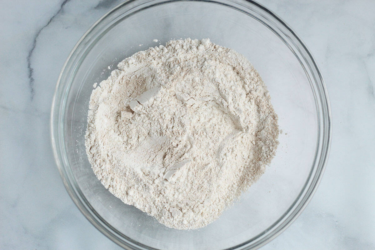 dry ingredients for lemon blueberry muffins in bowl.