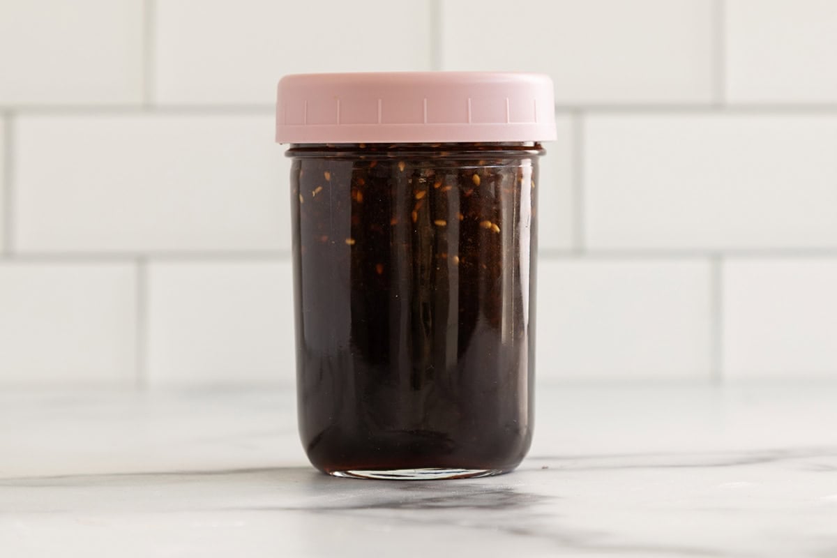 Teriyaki sauce in glass jar with lid.