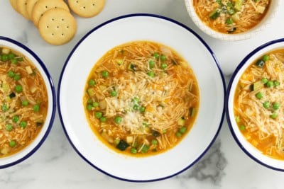 Vegetable noodle soup in bowls with sides.