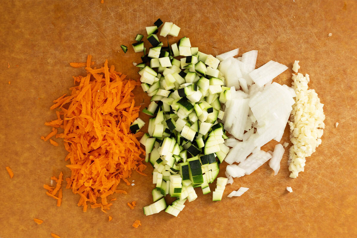 Chopped vegetables on cutting board for vegetable soup.