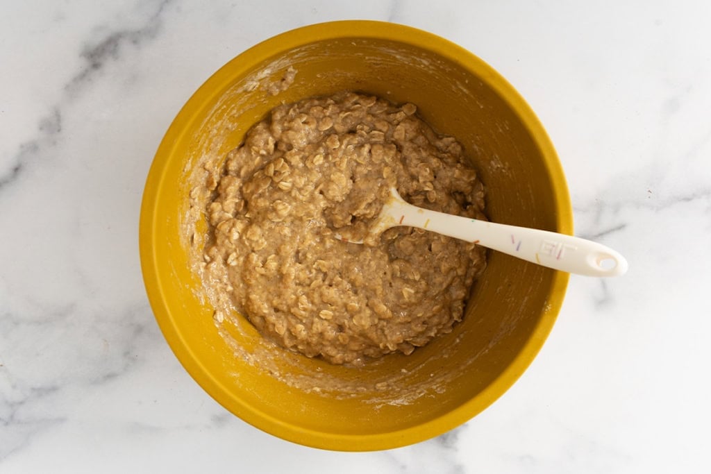 Batter for applesauce cookies in yellow bowl.