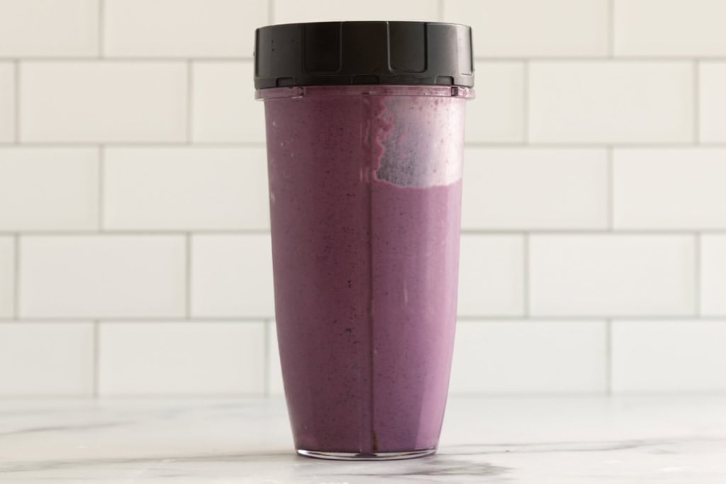 Blueberry smoothie in blender after blending.