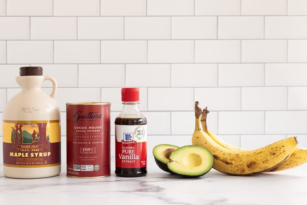 Ingredients for chocolate banana popsicles on countertop. 