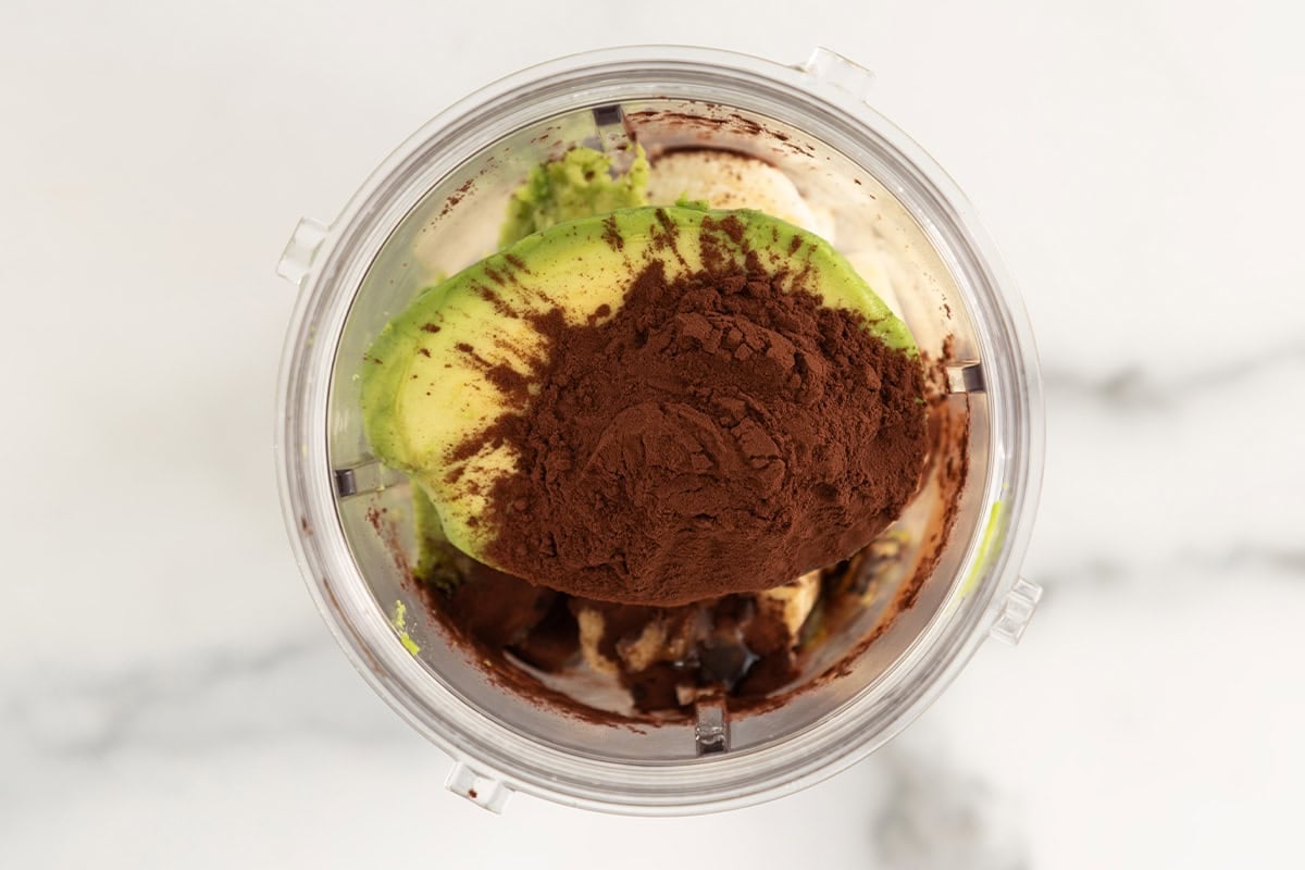 Ingredients for chocolate banana popsicles in blender before blending.