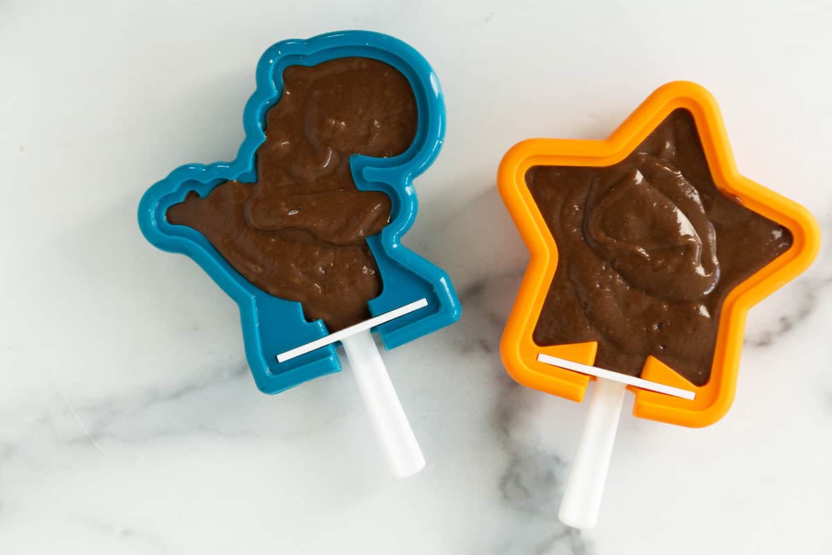 Chocolate banana popsicles in molds before freezing.