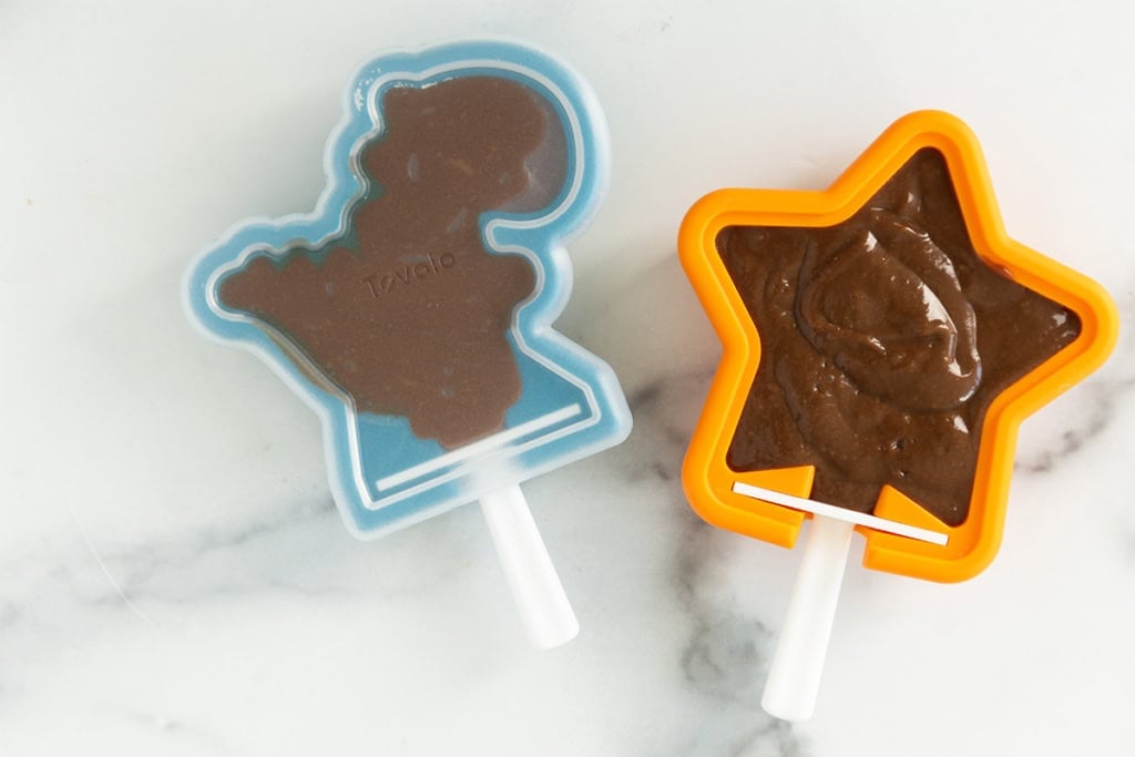 Chocolate banana popsicles in molds before freezing.